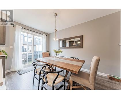 A dining room with a wooden table and chairs.