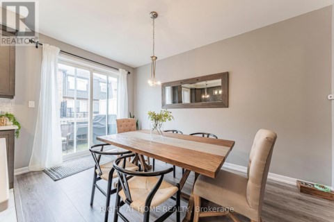 A dining room with a wooden table and chairs.