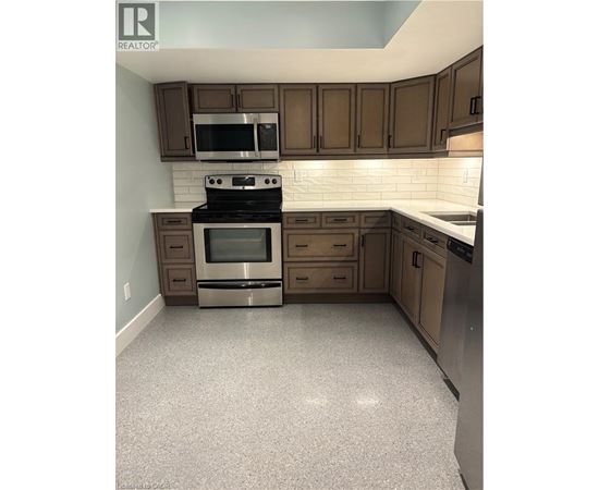 A kitchen with a stove top oven and microwave.