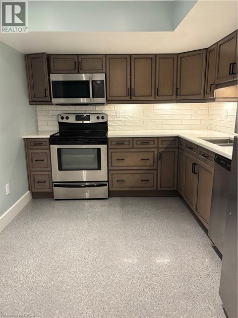 A kitchen with a stove top oven and microwave.