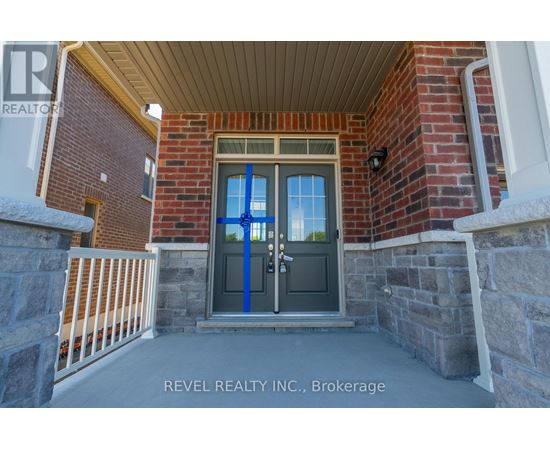 A house entrance with a blue door and a sign that says REVEL REALTY N.C. Brokerage.