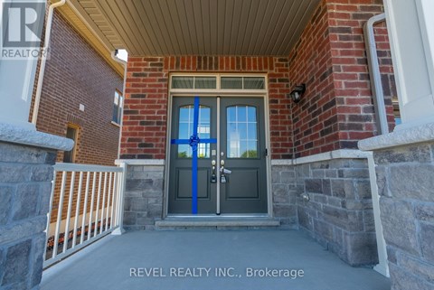 A house entrance with a blue door and a sign that says REVEL REALTY N.C. Brokerage.