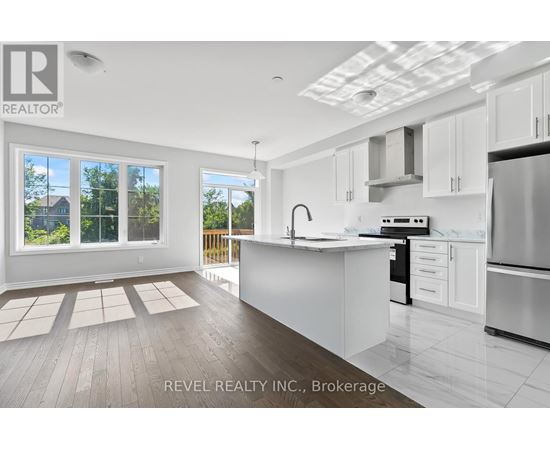 A modern kitchen with white cabinets and stainless steel appliances.