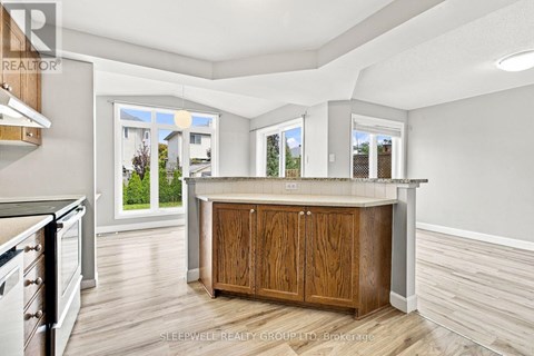 A kitchen with a wooden island and cabinets.