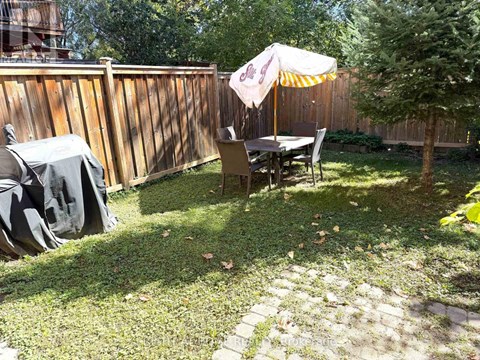 A patio with a table and chairs under an umbrella.