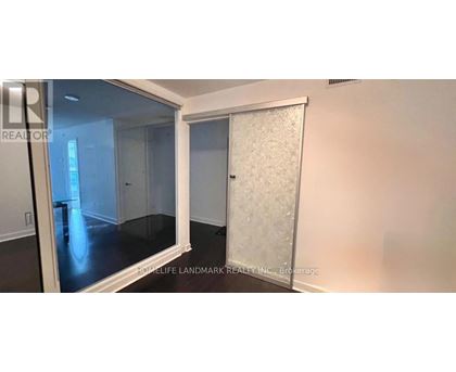 A room with a glass door and a white door with frosted glass.