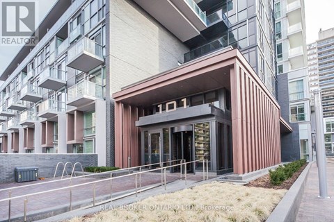 A modern building with a brown facade and glass windows is labeled with the number 01.