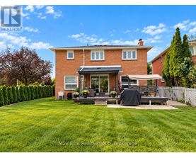 A house with a red brick exterior and a patio with a black tarp on it.