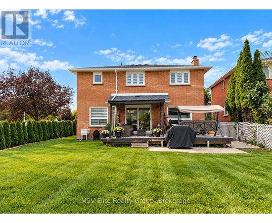 A house with a red brick exterior and a patio with a black tarp on it.