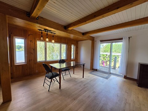 A dining room with a table and chairs.