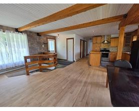 A living room with wooden floors and furniture.