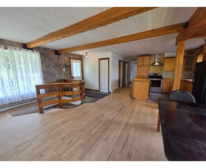 A living room with wooden floors and furniture.