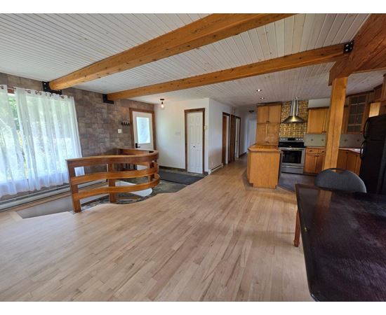 A living room with wooden floors and furniture.