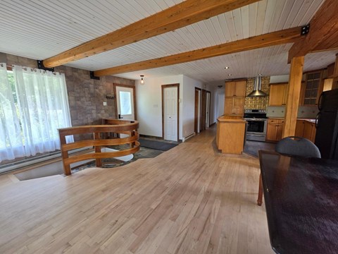 A living room with wooden floors and furniture.