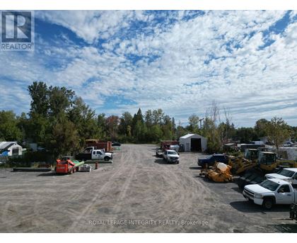 A parking lot with several vehicles and a construction site in the background.