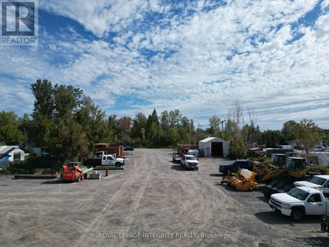 A parking lot with several vehicles and a construction site in the background.
