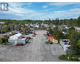 An aerial view of a parking lot with a few cars and a truck.
