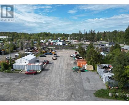 An aerial view of a parking lot with a few cars and a truck.