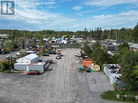 An aerial view of a parking lot with a few cars and a truck.