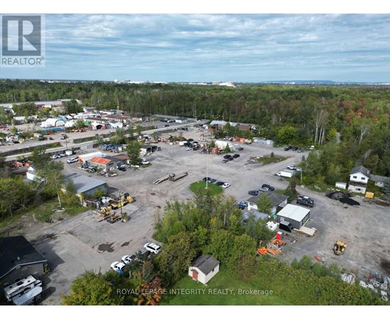 An aerial view of a construction site with a large parking lot and several buildings.