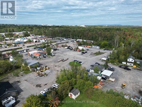 An aerial view of a construction site with a large parking lot and several buildings.