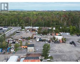 A large industrial area with a variety of vehicles and buildings.