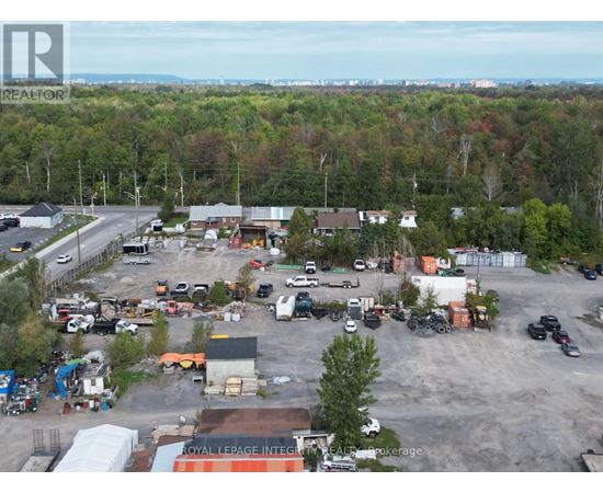 A large industrial area with a variety of vehicles and buildings.