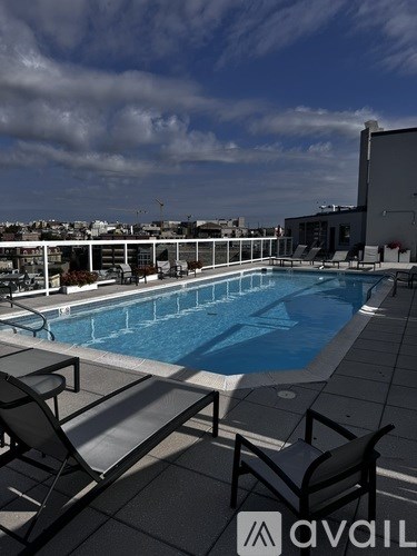 A pool with chairs and a logo that says "avail".