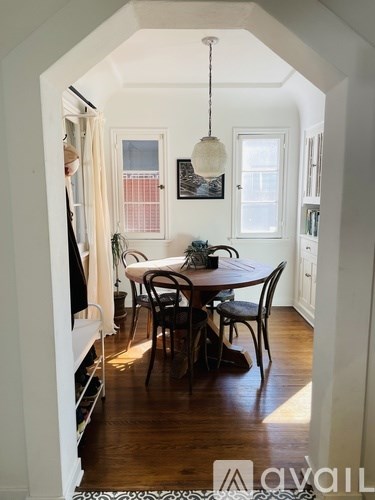 A dining room with a table and chairs.