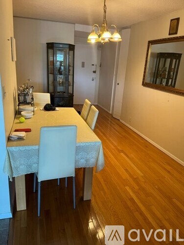 A dining room with a wooden table and chairs.