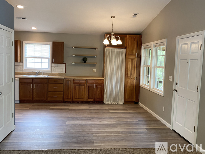 A spacious kitchen with wooden cabinets and a large island.