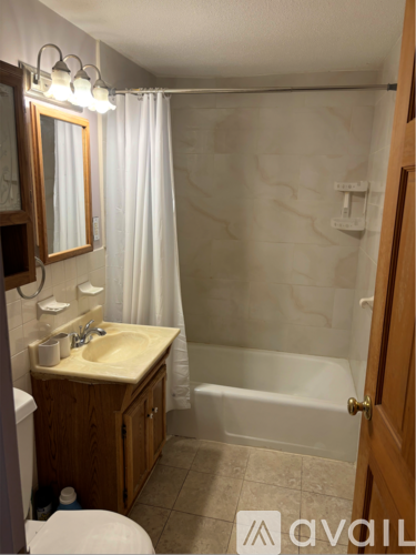 A bathroom with a sink, toilet, and bathtub.