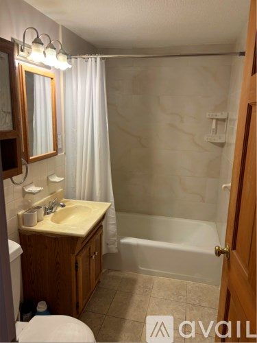 A bathroom with a sink, toilet, and bathtub.