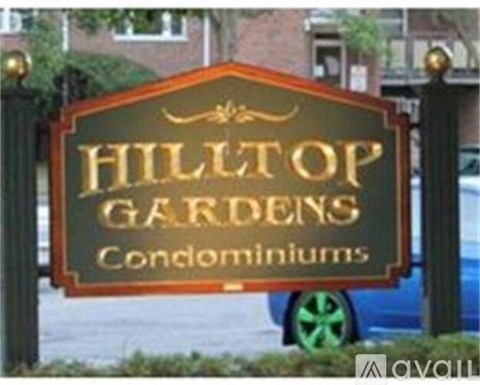 A sign that says Hilltop Gardens Condominiums.