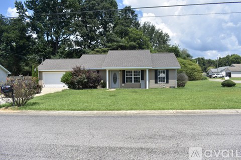 A house with a grey roof and a green lawn.