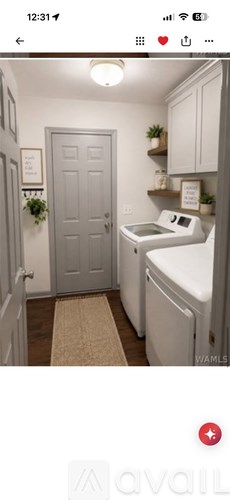 A small laundry room with a washer and dryer.