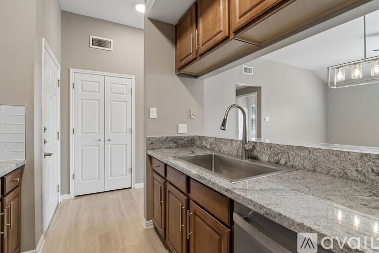 A kitchen with a sink and a white door.