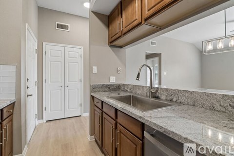 A kitchen with a sink and a white door.