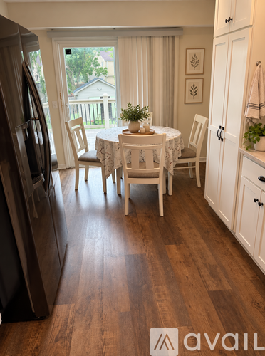 A kitchen with a table and chairs in the middle of the room.