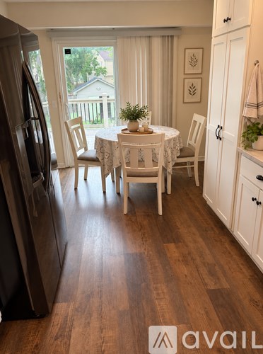 A kitchen with a table and chairs in the middle of the room.