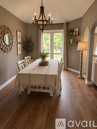 A dining room with a wooden table and chairs.