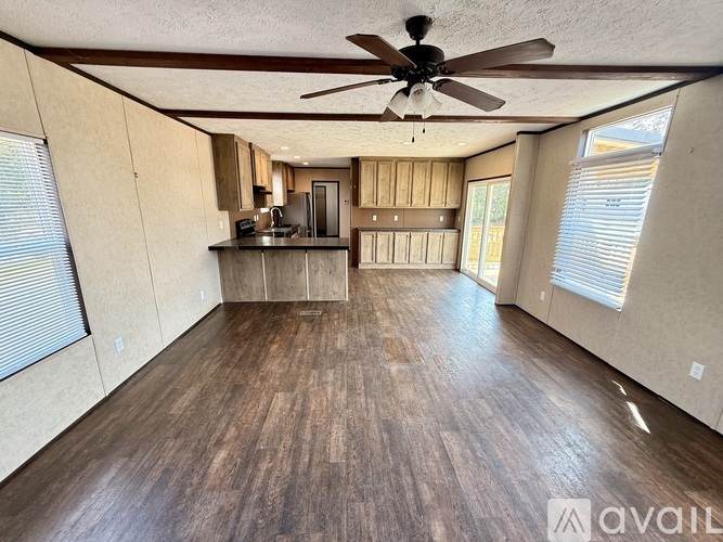 A kitchen with wooden cabinets and a black countertop.