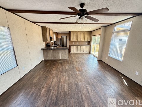 A kitchen with wooden cabinets and a black countertop.