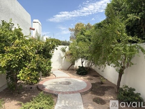 A garden with a circular walkway and a variety of plants.