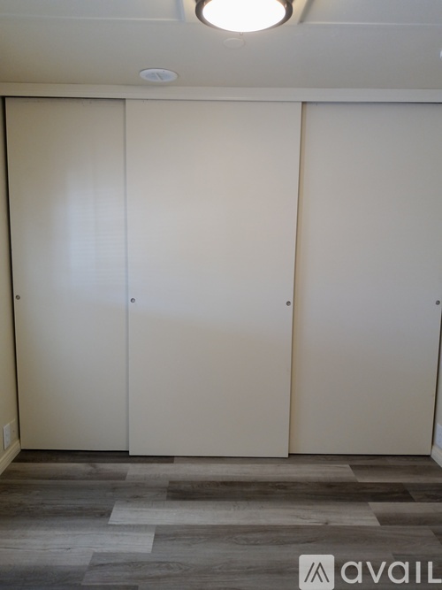 Three white doors in a room.