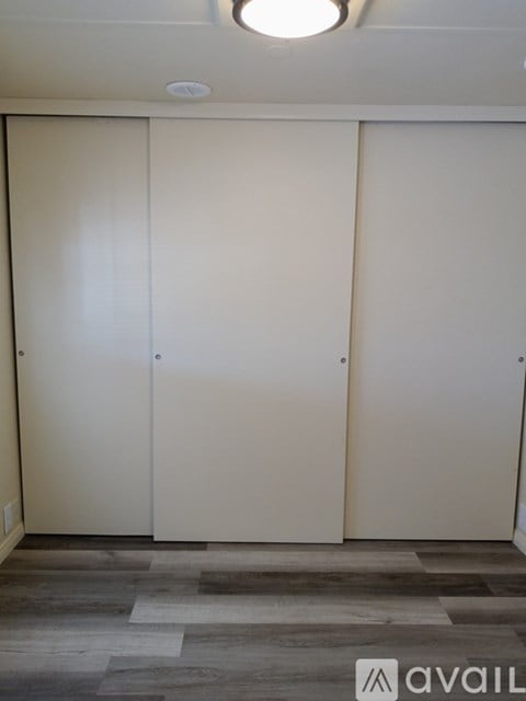 Three white doors in a room.