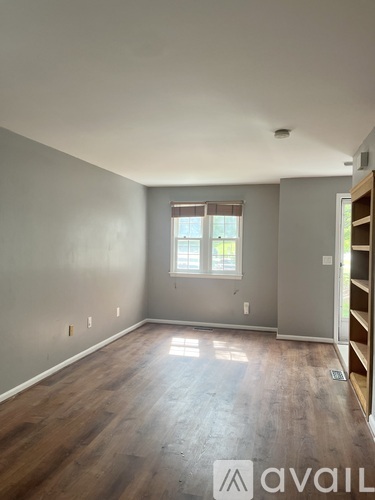 A room with wooden floors and a window.