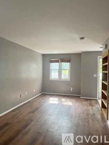 A room with wooden floors and a window.