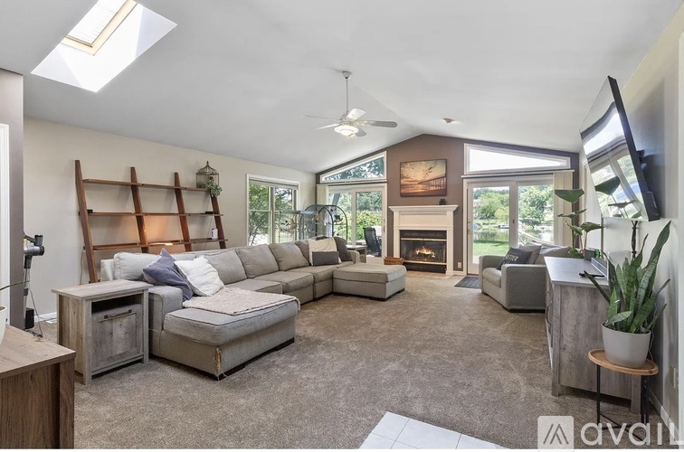 A living room with a grey sofa and a wooden table.