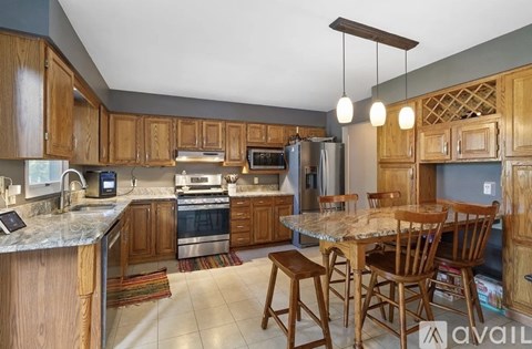 A kitchen with wooden cabinets and a granite countertop.